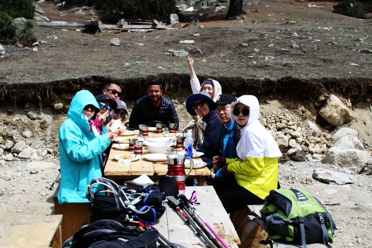 Travellers sharing a meal outdoors in the mountains